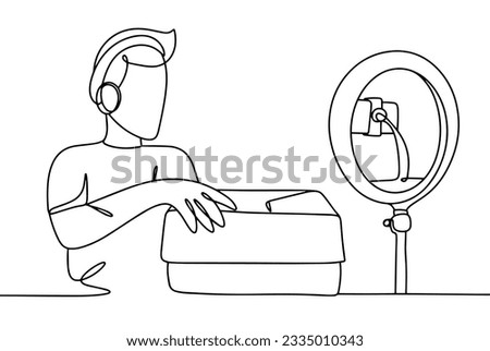 The blogger films the unpacking of goods in front of the camera. Advertising for subscribers. World Bloggers Day. One line drawing for different uses. Vector illustration.