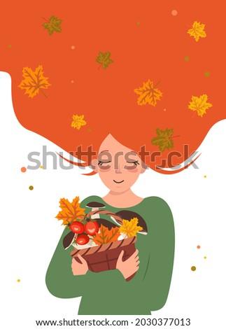 A young woman with red hair hugs a basket of mushrooms and clover leaves. Happy girl is waiting for autumn. Care and love for nature and the world
