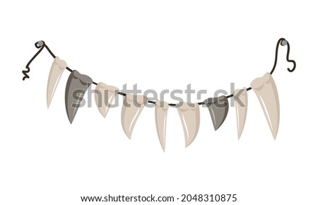 Beads of fangs and teeth hanging from a rope. Halloween party decoration or necklace