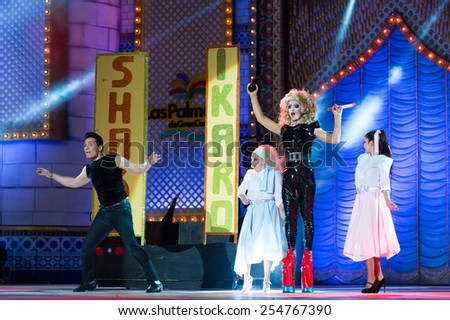 CANARY ISLAND, SPAIN - FEBRUARY 20, 2015: Drag Ikaro (m) as Olivia Newton John from the movie Grease and unidentified assistants with Grease costumes performing onstage during Drag Queen Gala.