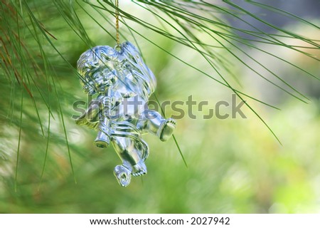 Angel playing in a pine tree  (Some green reflex ions in figure)
