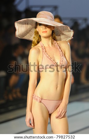 CANARY ISLANDS - 18 JUNE: Model Janeta Stamp wearing swimwear from Dos Mares Summer Collection at Moda Calida in Maspalomas June 18, 2011 in Canary Islands, Spain