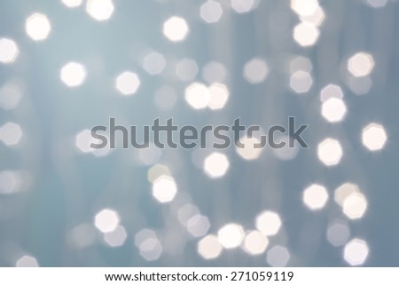 Beautiful defocused LED lights filtered bokeh abstract with light-green tone background.