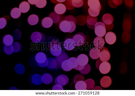 Beautiful defocused LED lights filtered bokeh abstract with purple-red tone background.
