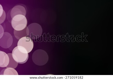 Beautiful defocused LED lights filtered bokeh abstract with purple-black tone background.
