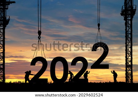 Silhouette of staff works as a team to prepare to welcome the new year 2022