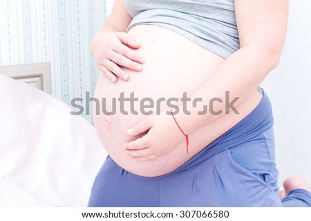 Belly of a pregnant woman. Pregnant woman touching her belly.