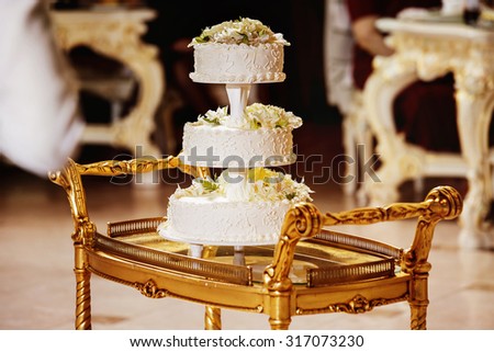 Image of tasty traditional wedding white cake with flowers figures.