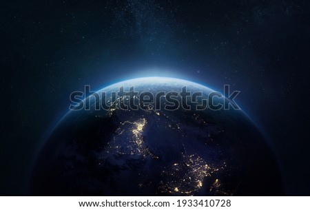 Nightly Earth planet in outer space. City lights on planet. Life of people. Solar system element. Elements of this image furnished by NASA