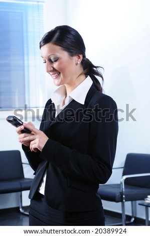 businesswoman uses telephone and smiles