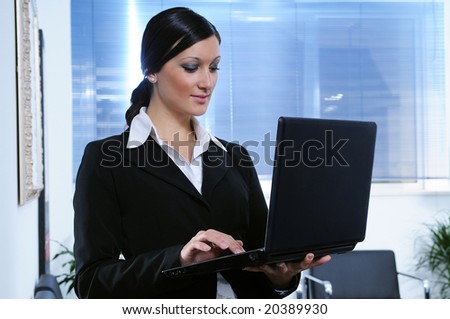 young businesswoman uses laptop with wireless mode