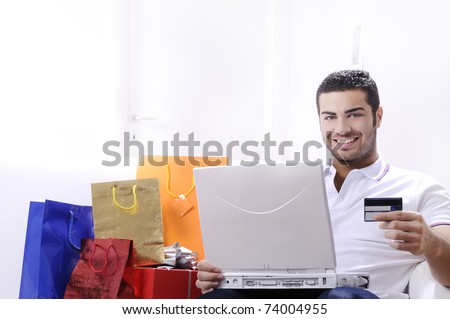 young man buying on internet with laptop in indoor