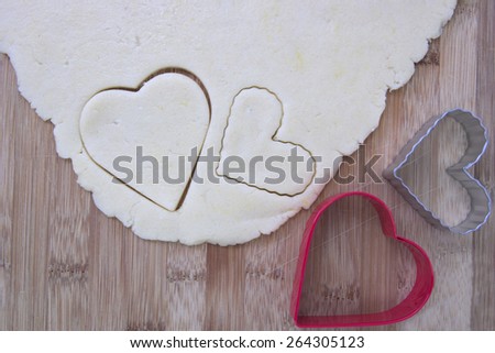 Sugar cookie dough with heart shaped cookie cutters