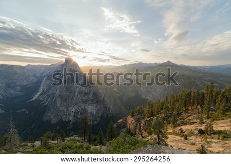 Beams of the sun make the way through Half Dome peak. Sierra Nevada mountains, Yosemite National Park, California
