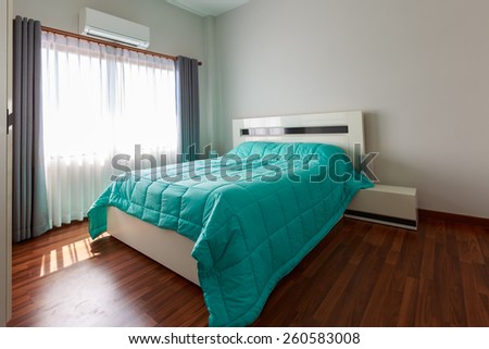 Bedrooms white with a green blanket on the floor wood exposure mild morning air atmosphere