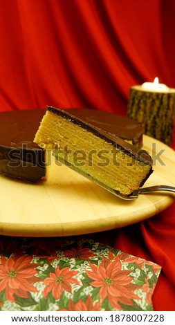 A slice of traditional German Christmas Cake Baumkuchen, Schichtkuchen on a red background Stock foto © 