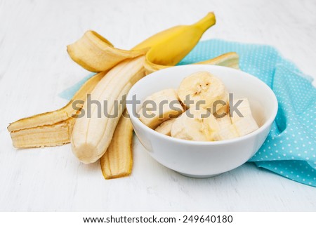 Fresh banana in a bowl on a old white wooden background