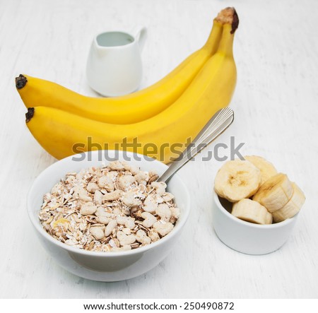 Banana and muesli on a old white wooden background