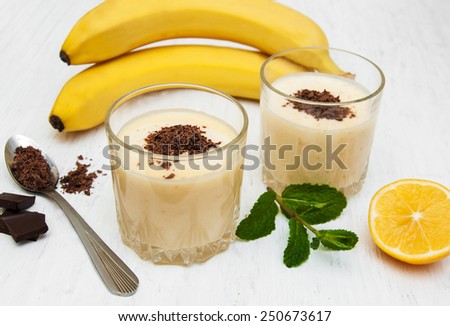 Banana smoothie with chocolate on a old white wooden background