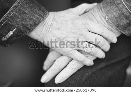 a black and white photo of an elderly couple still showing affection