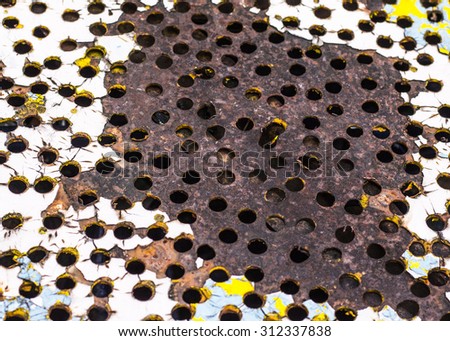 grunge  rusty metal with many hole and colorful old painted  texture  background