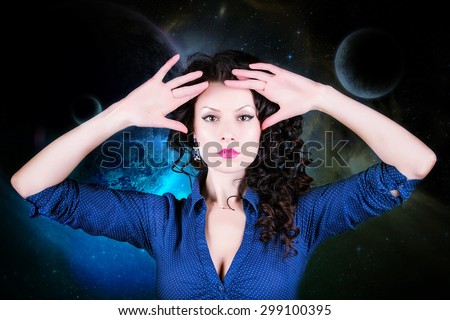 Caucasian brunette woman holding her hands near the head on the cosmic background. Astrology, numerology