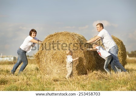 Family. Father, mother, daughter and son. Family in wheat field.