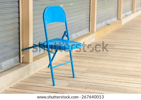 blue chair on wood floor. soft focus effect.
