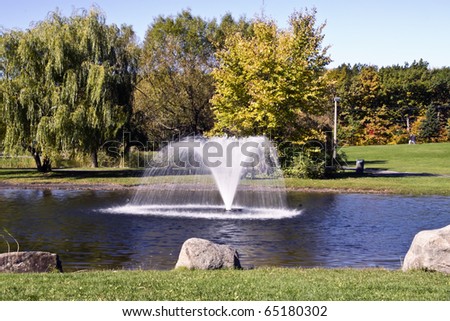 Small fountain in a lake in Autumn