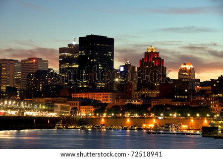 Some office buildings in Montreal, behind a part of the port at night