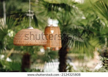 Wicker lampshade in an outdoor street cafe. Vintage decorative Stock foto © 