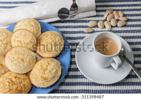 A plate of cookies and ingredients to prepare the recipe and a cup of coffee