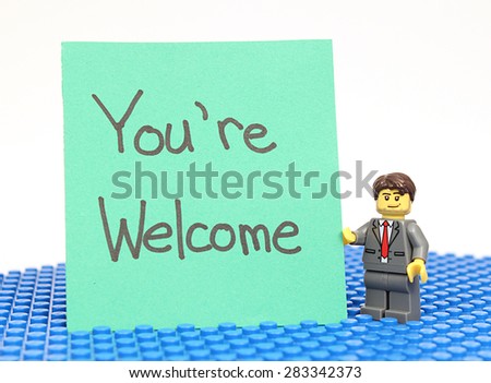 Colorado, USA - June 1, 2015: Studio shot of Lego minifigure with You\'re Welcome sign. Legos are a popular line of plastic construction toys manufactured by The Lego Group, a company based in Denmark.