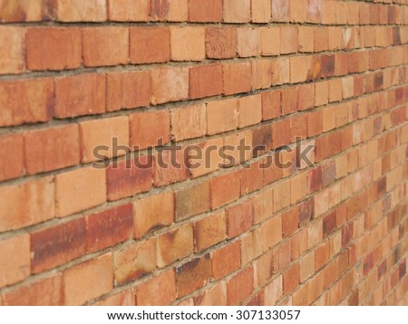 Rough brick wall of earth and terracotta colored bricks at an residential wall in Melbourne