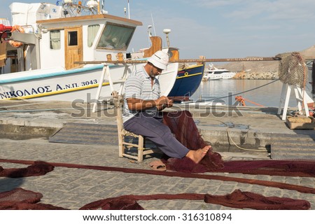 Paros, Greece 15 August 2015. Fisherman repairing the net at Paros island in Greece.