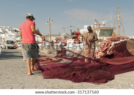 Paros, Greece 15 August 2015. Fishermen on their morning routine job at Paros island in Greece.