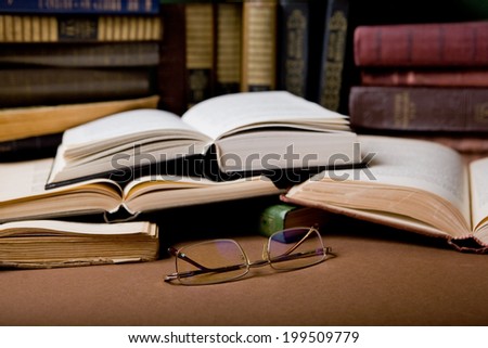glasses on the open book in the library