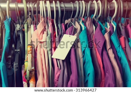 Blank price label on clothes hang on a shelf