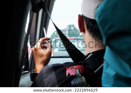 Image, Stock Photo Adult man smoking while looking at camera during sunset