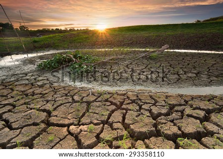 Dry river on drought parched ground in twilight.