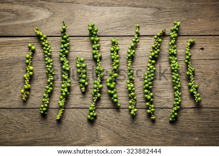 Green peppercorns on rustic wood background, Dark mood of food photography with green peppercorns, Still life photography with overhead view with green peppercorn