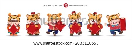 2022 Chinese new year, year of the tiger. Cute little kids and tigers holding blank red blessing card for your own text.