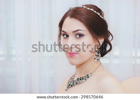 beautiful girl with sparkling jewelry and perfect skin is waiting for her wedding
