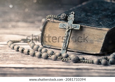 Detail studio shot of very old, vintage Holy Bible with lots of ornaments on the cover and yellow pages and old rosary on vintage wooden desk Christianity concept. Time of prayer. Stock foto © 