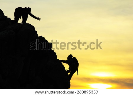 climbing silhouette and spirit of togetherness