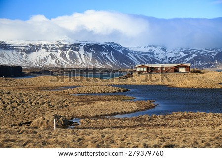 House against mountain, Typical Icelandic house which face the pond and surround by mountain.