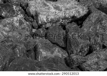 Thailand / June 2015. Black and White Rocks background. The rocks was scattered along the shore line to prevent land erosion and it creates nice pattern.