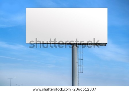 Billboard outdoor advertising, mockup billing board in front of a blue sky. Blank white background for branding design large hoarding Stock foto © 