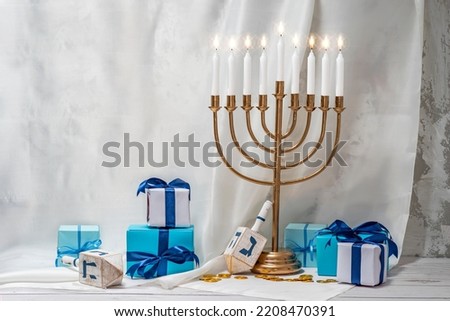 Jewish Hanukkah Menorah 9 Branch Candlestick, dreidel, gift boxes. Holiday Candle Holder, dreidl. Nine-arm candlestick. Traditional Hebrew Festival of Lights candelabra. Background with copy space. Сток-фото © 