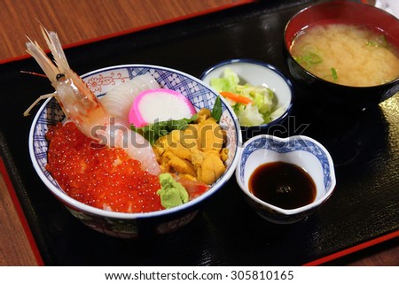 Japanese cuisine - uni don set. The uni don (sea urchin rice bowl) is served with uni, salmon eggs, raw shrimp and octopus on vinegar rice.